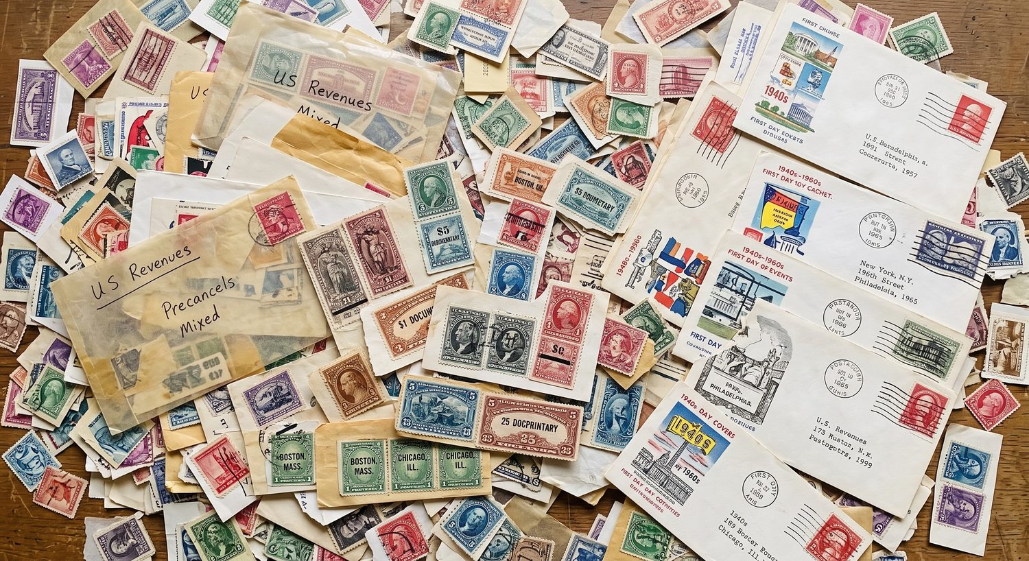 Scattered vintage stamp accumulation featuring U.S. revenues, precancels, and First Day Covers