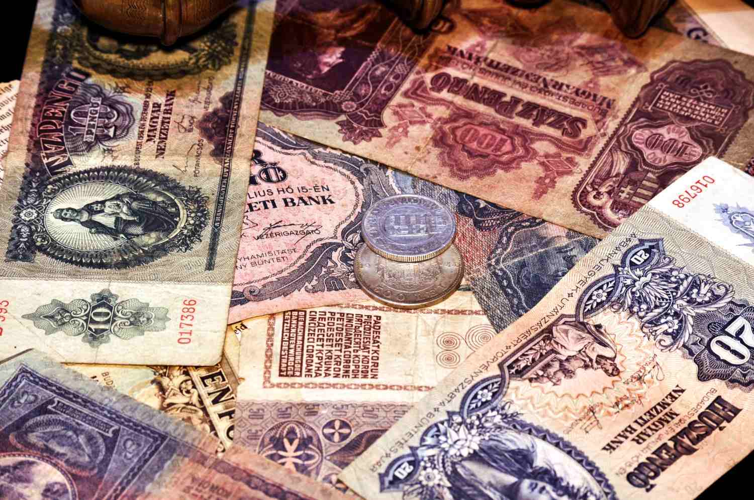 A stack of vintage U.S. paper currency fanned out on a table