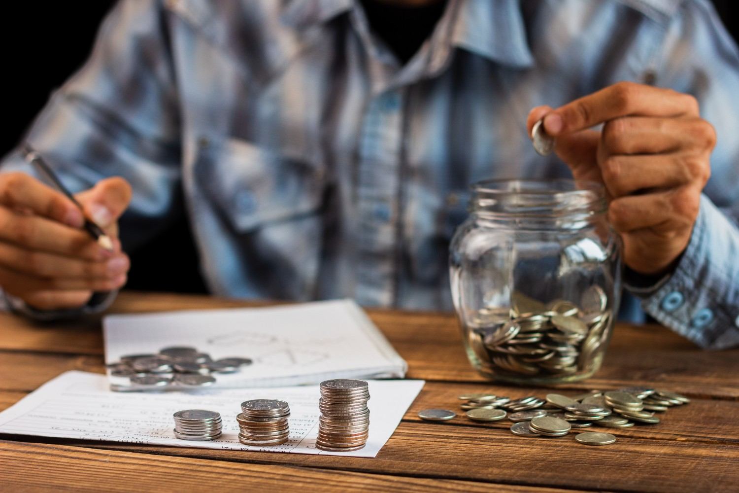 A collector reviewing coins with a loupe at a desk