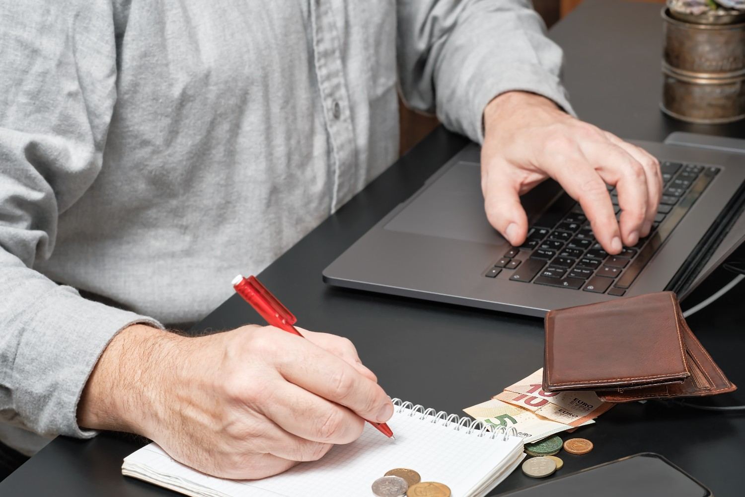 An open vintage stamp album being examined with a magnifying glass