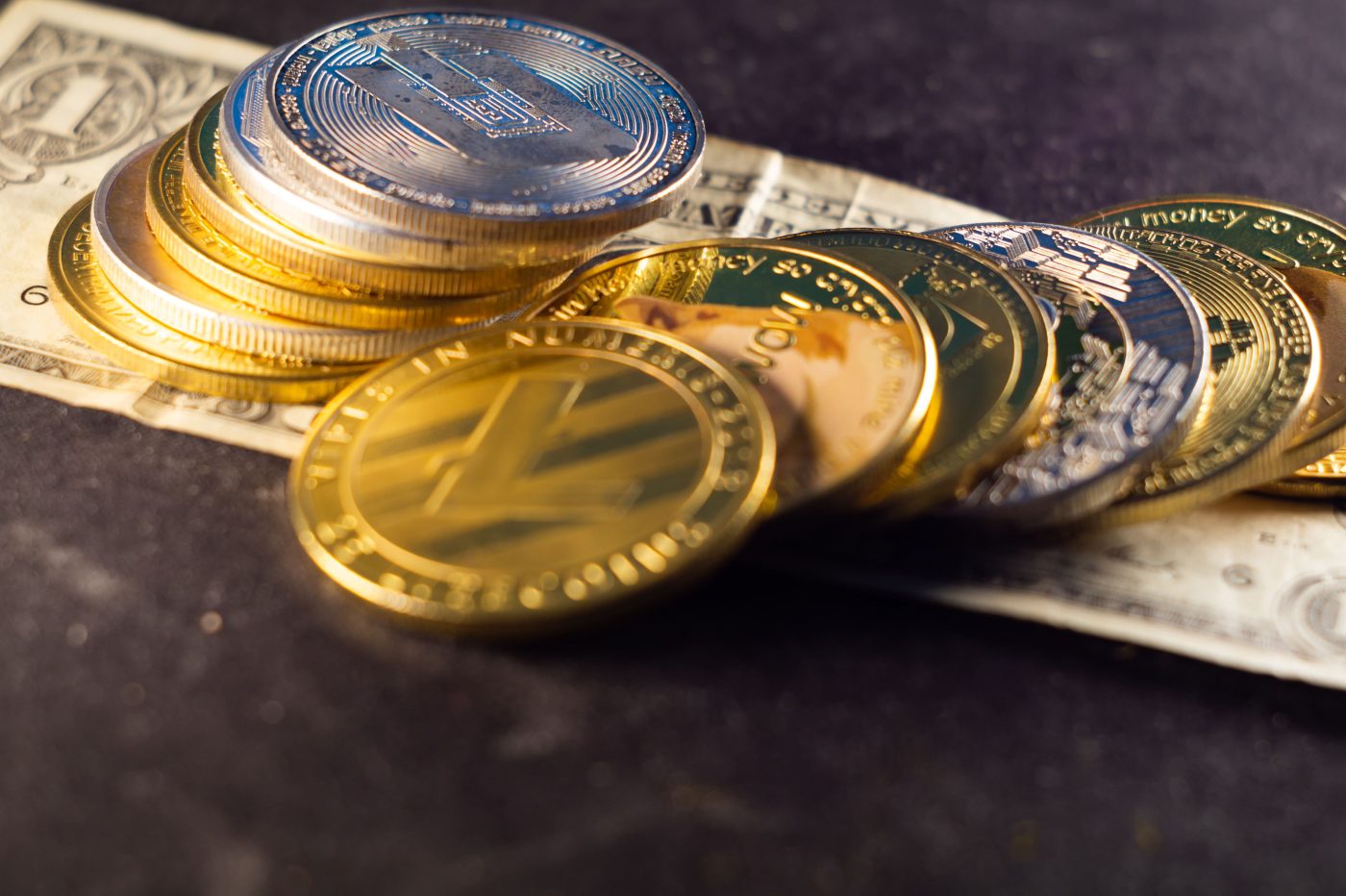 A pile of collectible coins on top of paper currency